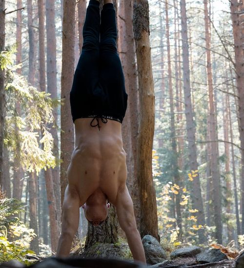 Man performing a controlled strength exercise in a calm environment.